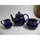 A Royal Doulton Cobalt Blue Glazed Three Piece Teaservice