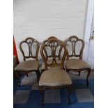 A Set of Four Pierced Splat Dining Chairs on Front Cabriole Legs