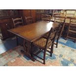 An Oak Refractory Dining Table and Four Ladder Back Chairs