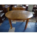 An Edwardian Oval Walnut Dining Table,