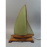 A Vintage Wooden Novelty Table Lamp in the Form of a Sailing Boat,