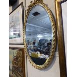 An Oval Gilt Framed Wall Mirror,