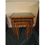 A Nest of Three Tooled Leather Topped Tables