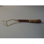 A Wooden Handled Bone Fishing Priest,