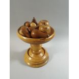A Turned Wooden Bowl Containing Treen Fruit,