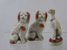 Three Miniature Staffordshire Figures of Dogs, including two spaniels and one seated greyhound. (3)