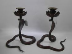 A Pair of Indian Brass and Enamel Candle Sticks, in the form of cobras, together with a copper