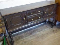 Elizabethan Style Oak Dresser Base, having two central drawers with cupboards on either side