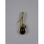 A Lady's 9ct Gold Garnet Cabachon Treble Clef Pendant, approx 11 x 9 mm, approx 3.8 gms