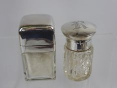 Two Silver Topped Vanity Jars, Birmingham hallmark dated 1902 the other with rubbed marks. (2)