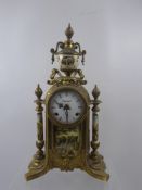 An Italian Imperial Gilt Brass Mantel Clock, painted landscape panels with porcelain face and