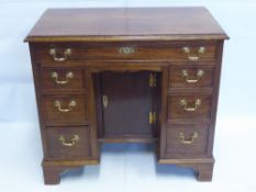 A Lady's Cottage Style Mahogany Knee Hole Desk. The desk having single drawer to top with three