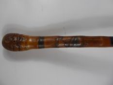 An Antique Wood Carved Walking Stick, the staff carved with tribal figures.