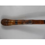 An Antique Wood Carved Walking Stick, the staff carved with tribal figures.