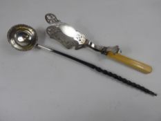 An Antique Brandy Ladle, with ebony twist handle, a silver plated cake tongs. (2)