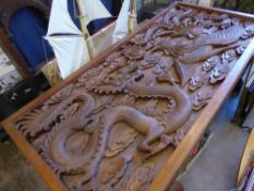 An Impressive Indonesian Hand Carved Teak Dining Room Table, the table having a heavily carved inset