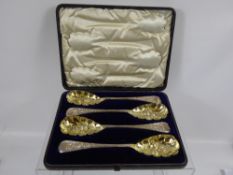 A Set of Four Solid Silver Victorian Berry Spoons, the spoons having gilded bowl, in original