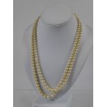 A Lady's Double Strand Pearl Necklace, the graduated pearl necklace held together with a 9ct gold