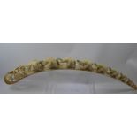 A Mid-19th Century Ivory Tusk, carved with approx nine graduated elephants and terminating with a