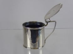 A Solid Silver Mustard Pot, Birmingham hallmark, dated 1912 with blue glass liner.