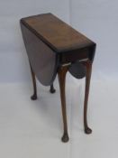 A Walnut Veneer and Drop Leaf Table, on pad feet, approx 88 x 60 x 61 cms.