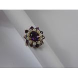 A Lady's 9 ct Amethyst and Opal Ring, the centre amethyst 9 x 7mm, 10 x 3mm amethysts and 10 x 3mm