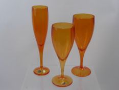 A Quantity of 'Tangerine' Bohemian Crystal, including four champagne flutes, four red wine and