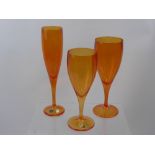 A Quantity of 'Tangerine' Bohemian Crystal, including four champagne flutes, four red wine and