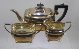 A Silver Tea Set, comprising tea pot, twin handled sugar bowl and milk jug, London hallmark, dated