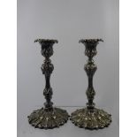 Two Pewter Nut Dishes, in the form of walnuts together with two plated candlesticks. (4)