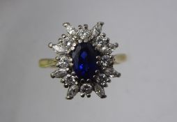 A Lady's 18 ct Yellow and White Gold Sapphire and Diamond Ring, the sapphire 7.7 x 5 mm, 8 x round