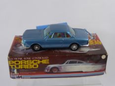 A Bandai Vintage Corded Remote BMW, together with a 'Lucky' remote Porsche Turbo in original box. (