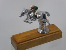 A Chrome Figure of a Race Horse, and enamel jockey on a wooden plinth, approx 17 cms high x 20 cms