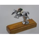 A Chrome Figure of a Race Horse, and enamel jockey on a wooden plinth, approx 17 cms high x 20 cms