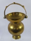 An Early 20th Century Brass Spittoon, waisted bulbous form with decorative handle approx 35 cms