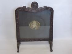 A Victorian Oak Framed Silk Embroidered Fire Screen, the screen depicting a peacock, the frame