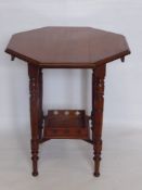 An Edwardian Octagonal Table, turned legs with tray support, approx 64 x 74 cms