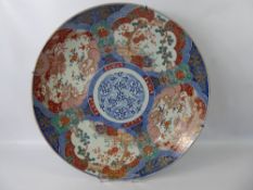 A 19th Century Japanese Imari Charger, depicting dragons amongst cloud scroll, tree peony and