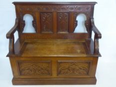 An Antique Oak Settle, decorative floral carving to frame and front panel, lift up lid, approx 104 x