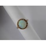 A Lady's 14 K Yellow Gold Opal and Diamond Cluster Ring, size P, the ring set with a single opal,