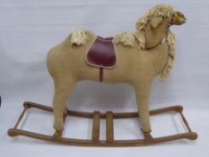 A Vintage Child's Rocking Camel, approx 145 x 105 cms. The camel having a pine base with wooden