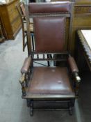 An Edwardian American Oak Rocking Chair, with burgundy leather seat and back.
