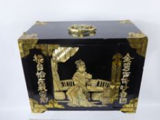 A Black Lacquer Oriental Jewellery Chest, with mother of pearl decoration, single folding door