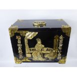 A Black Lacquer Oriental Jewellery Chest, with mother of pearl decoration, single folding door