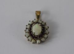 A Lady's 9ct Gold Garnet and Opal Pendant, the pendant with a centre opal approx 5 x 10 mm