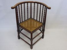 An Unusual Spindle Back Corner Chair, lengthened spindles within a crescent frame.