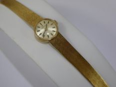 A Lady's 9 ct Gold Tissot Wrist Watch, the watch having a champagne dial with baton markers, case nr