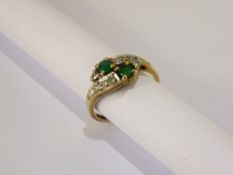 A Lady's 9 ct Gold Emerald and Diamond Cross Over Ring, emeralds 2 x 3.0 mm, 10 to 15 pts 8 cut