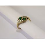 A Lady's 9 ct Gold Emerald and Diamond Cross Over Ring, emeralds 2 x 3.0 mm, 10 to 15 pts 8 cut