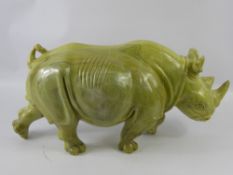 A Large Butter Jade/Hardstone Rhinoceros, approx 54 x 26 cms, signed David Sibanda. (af)